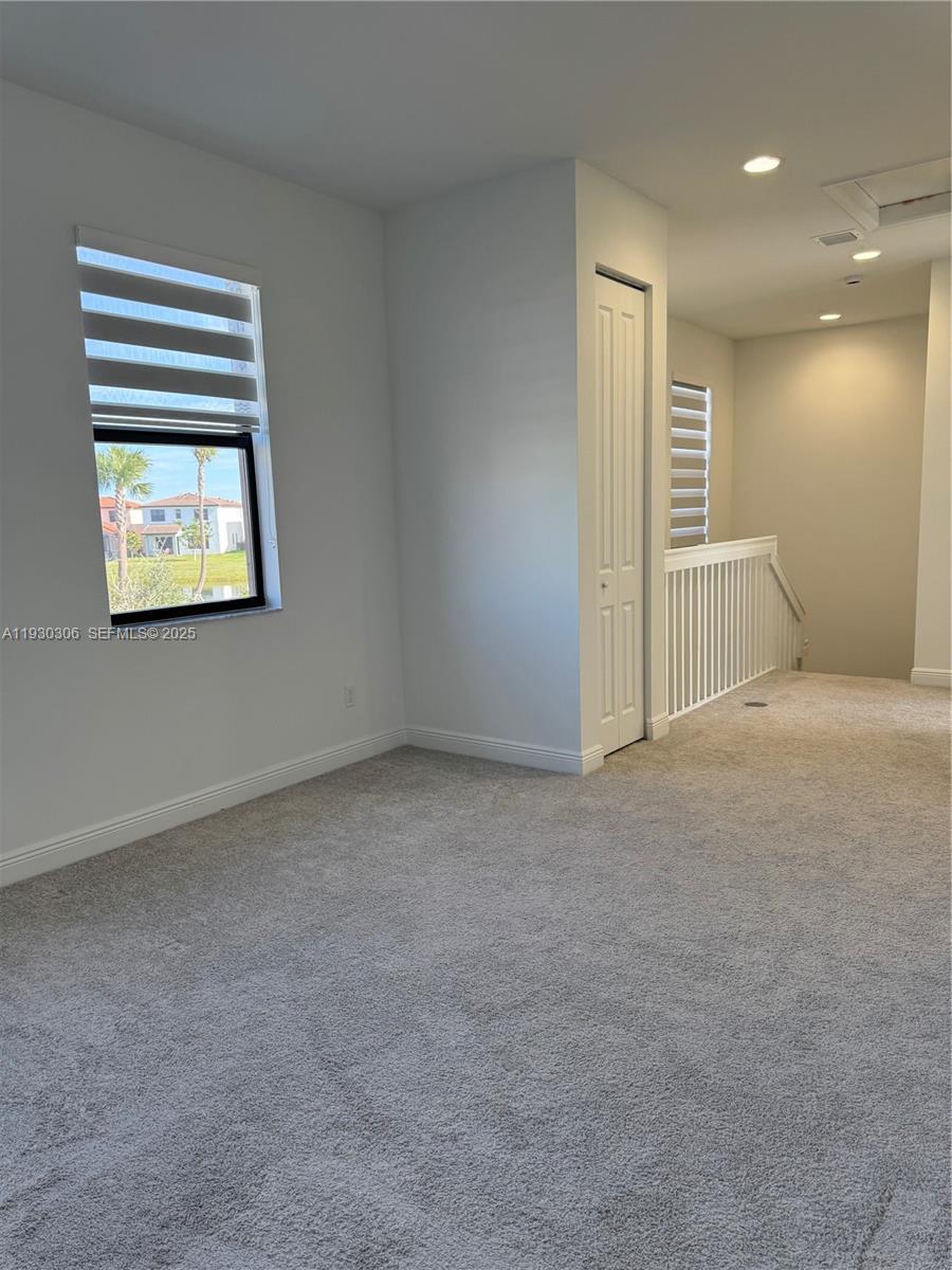 16456 Sea Turtle Place, Unit 16456 Westlake, FL 33470 - Photo 18 of 27 an empty room with windows and closet