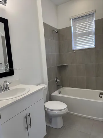 a bathroom with a toilet a sink and bathtub