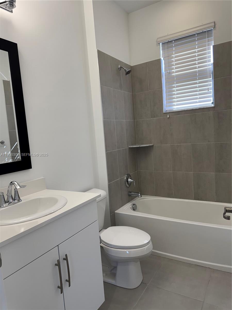 16456 Sea Turtle Place, Unit 16456 Westlake, FL 33470 - Photo 20 of 27 a bathroom with a toilet a sink and bathtub