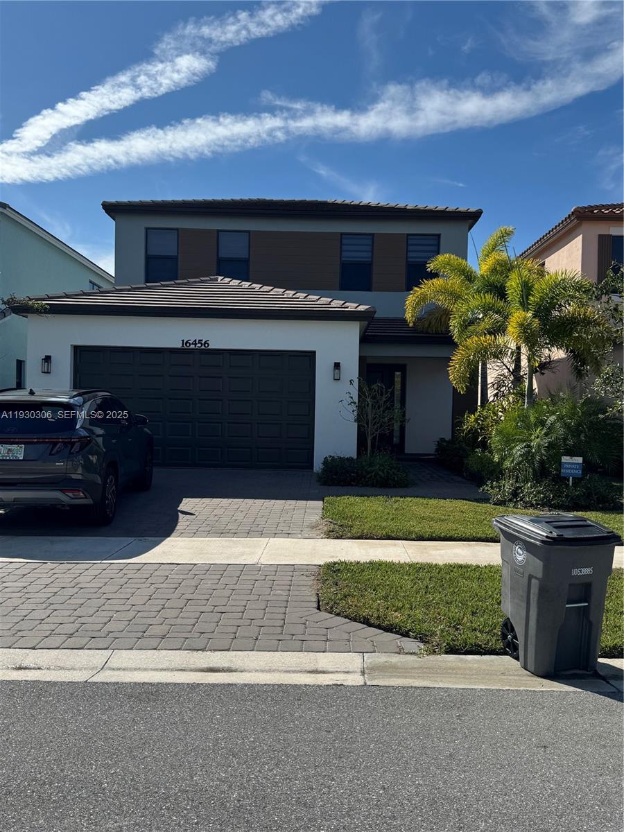 16456 Sea Turtle Place, Unit 16456 Westlake, FL 33470 - Photo 2 of 27 a front view of house with a garden