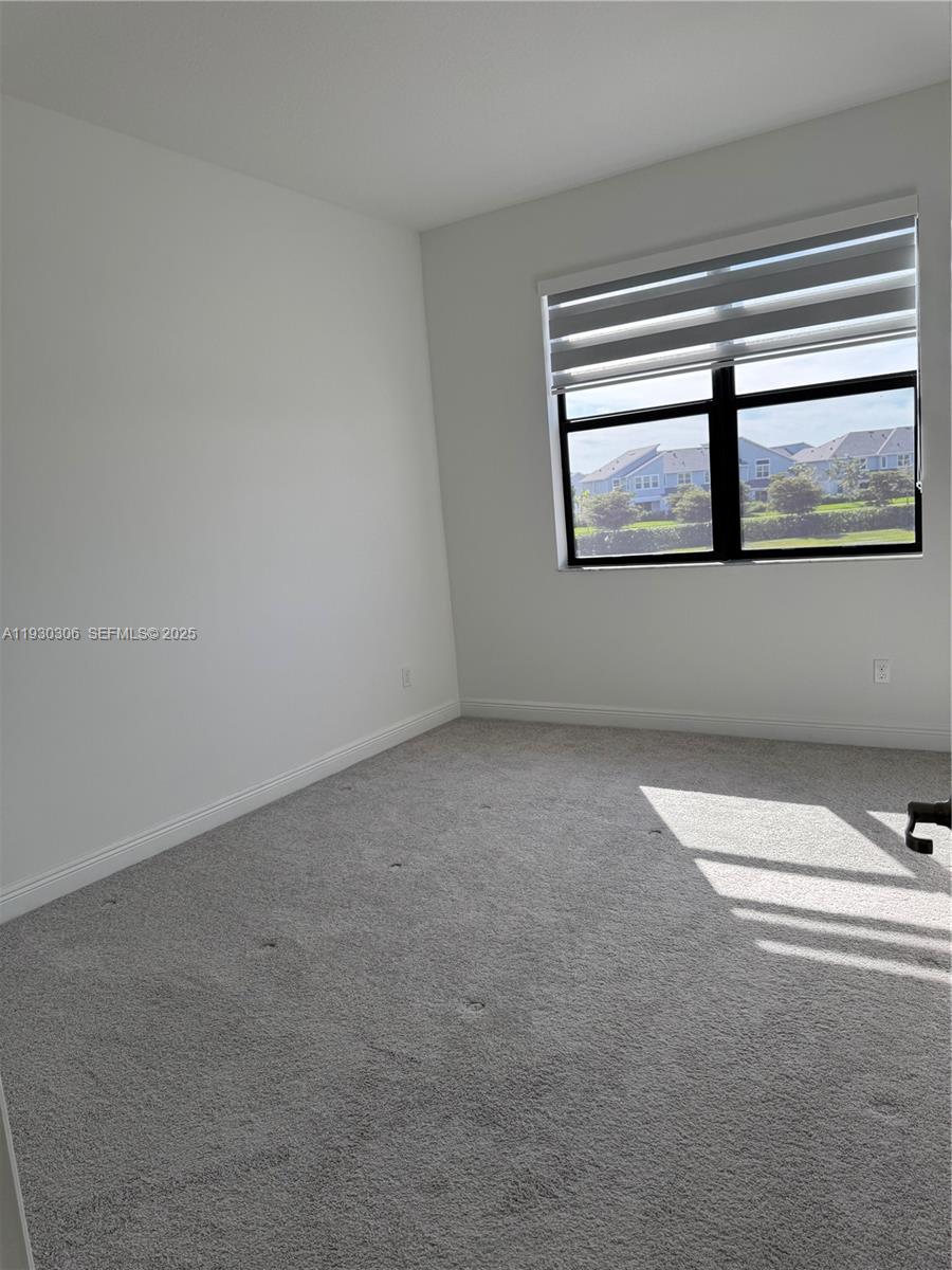 16456 Sea Turtle Place, Unit 16456 Westlake, FL 33470 - Photo 21 of 27 an empty room with windows and entrance