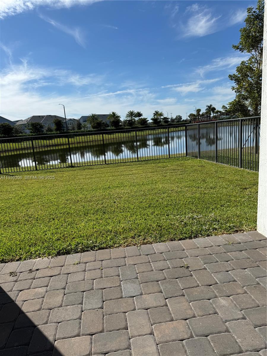 16456 Sea Turtle Place, Unit 16456 Westlake, FL 33470 - Photo 22 of 27 a view of a garden with a bench in the background