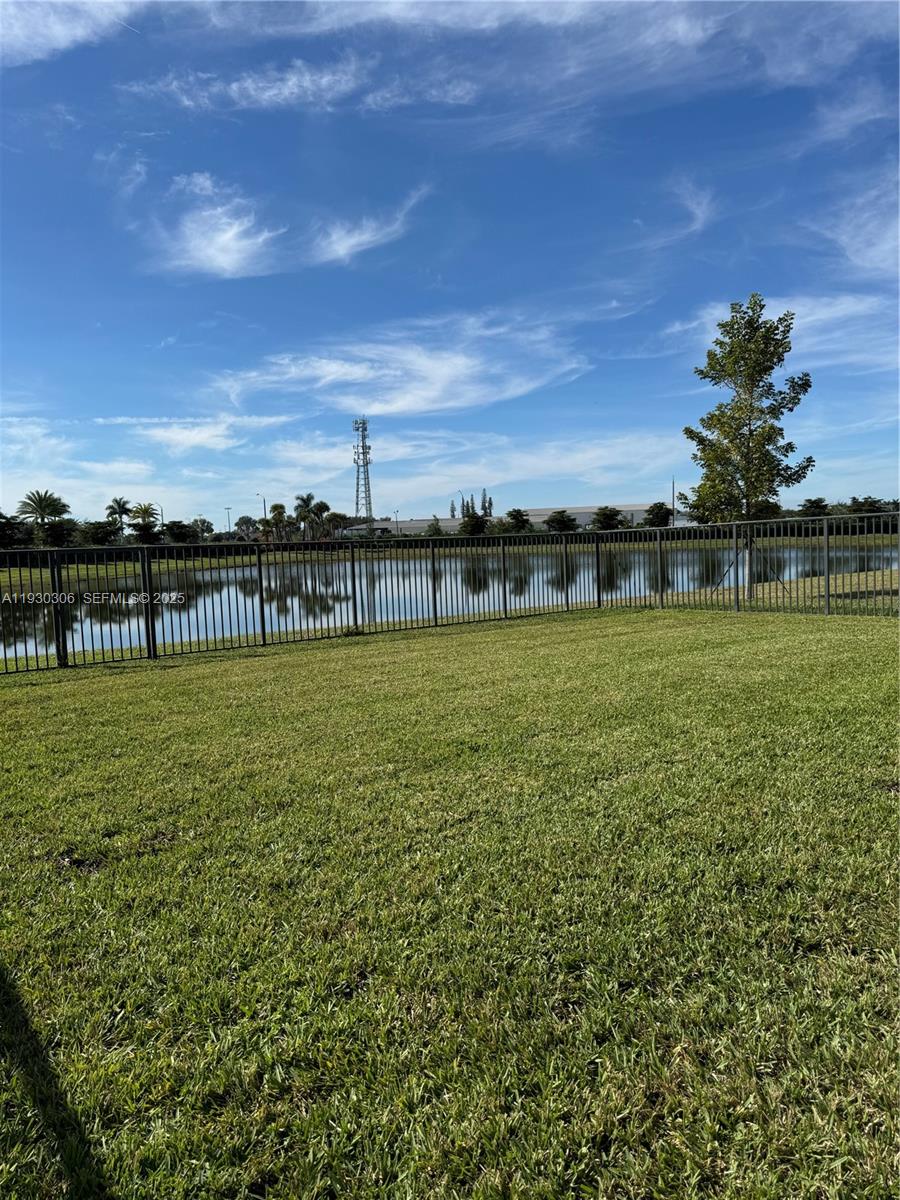 16456 Sea Turtle Place, Unit 16456 Westlake, FL 33470 - Photo 24 of 27 a view of a garden with a building in the background