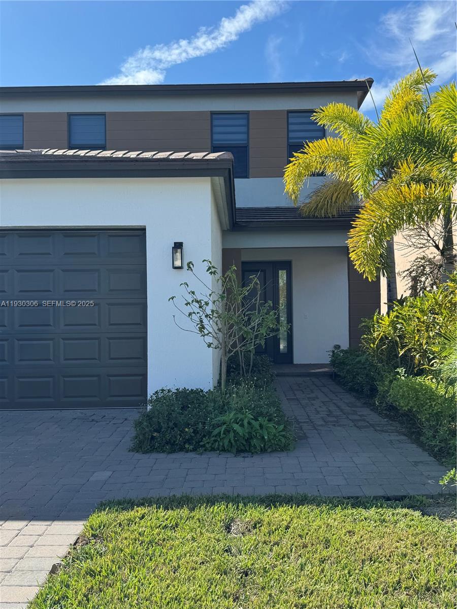 16456 Sea Turtle Place, Unit 16456 Westlake, FL 33470 - Photo 3 of 27 a front view of a house with a yard