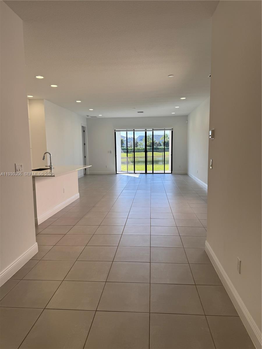 16456 Sea Turtle Place, Unit 16456 Westlake, FL 33470 - Photo 5 of 27 a view of an empty room with a window