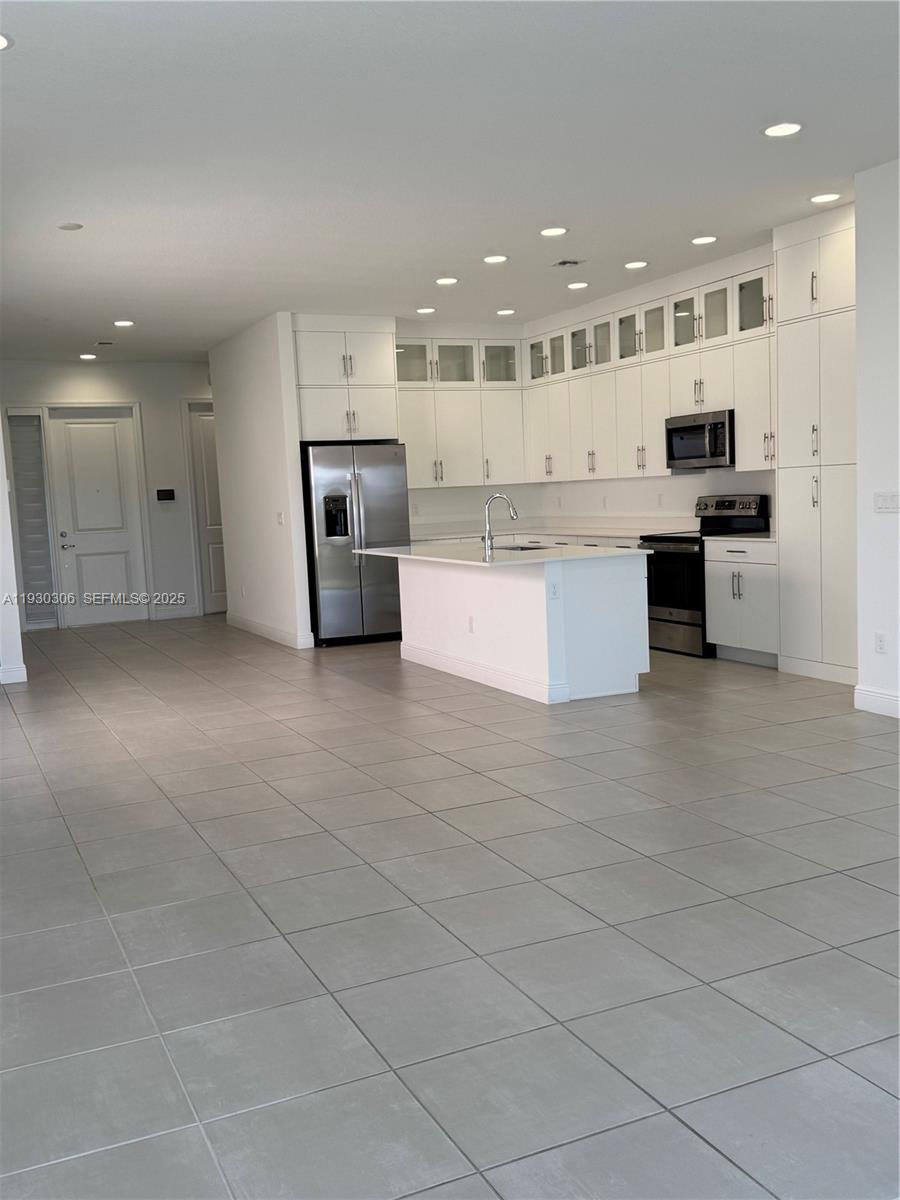 16456 Sea Turtle Place, Unit 16456 Westlake, FL 33470 - Photo 7 of 27 a large kitchen with stainless steel appliances kitchen island granite countertop a large counter top and stainless steel appliances