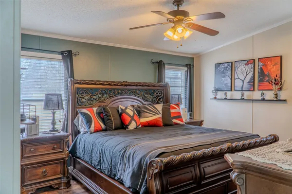 a bedroom with a bed and a chandelier