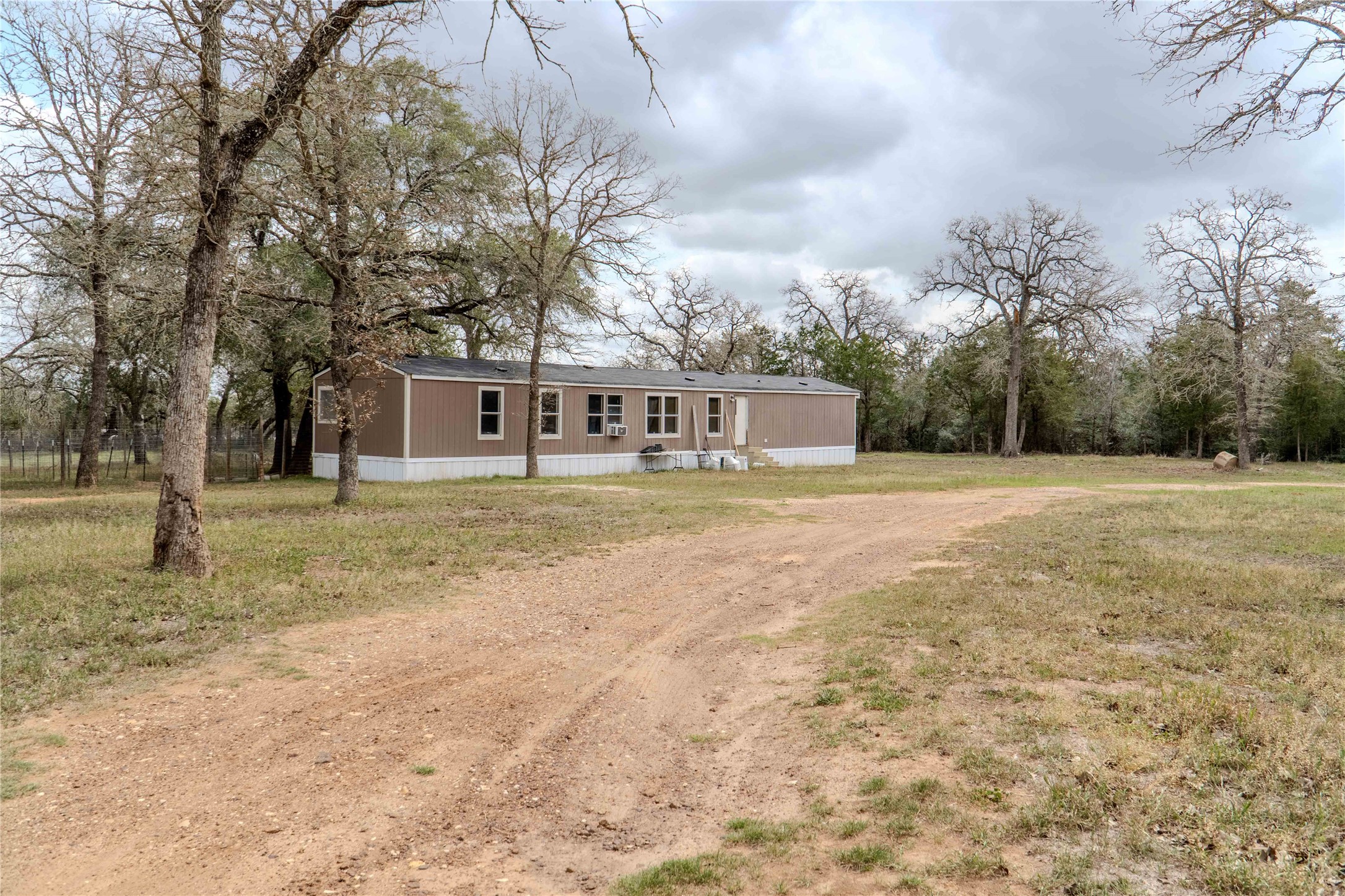 7519 Silvermine Road Harwood, TX 78632 - Photo 19 of 20 a view of a house with yard and trees