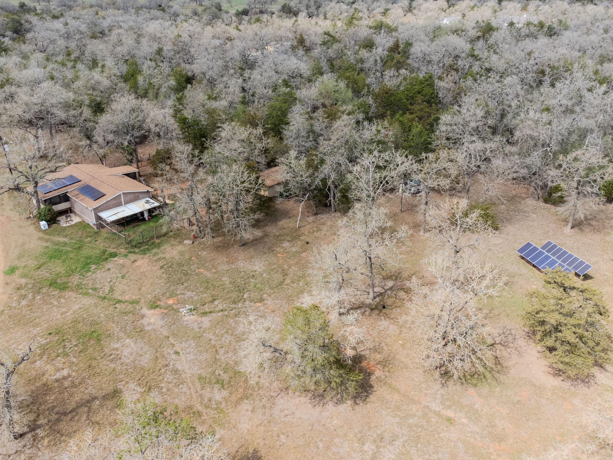 7519 Silvermine Road Harwood, TX 78632 - Photo 4 of 20 a view of a dry yard with wooden fence
