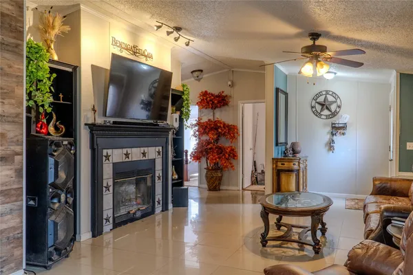 a living room with furniture a flat screen tv and a fireplace