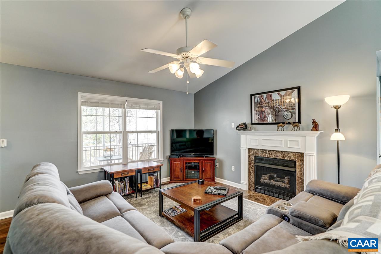 7 Haversack Road Palmyra, VA 22963 - Photo 16 of 32 a living room with furniture a fireplace and a flat screen tv