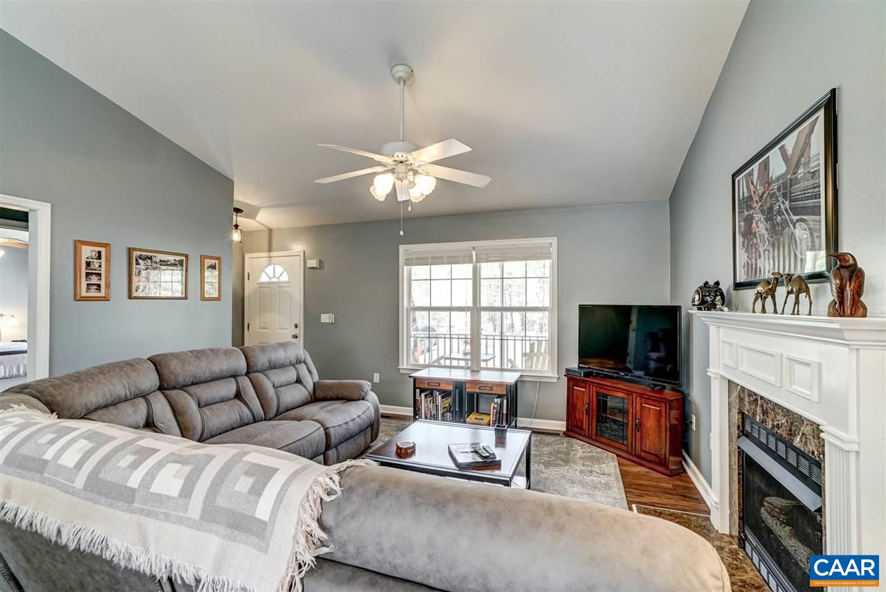 7 Haversack Road Palmyra, VA 22963 - Photo 17 of 32 a living room with furniture a fireplace and a flat screen tv