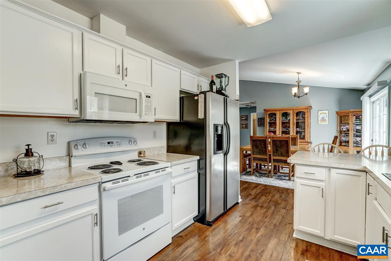 7 Haversack Road Palmyra, VA 22963 - Photo 24 of 32 a kitchen with granite countertop a refrigerator a stove a sink dishwasher and white cabinets with wooden floor