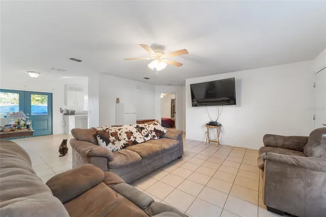 a living room with furniture and a kitchen view