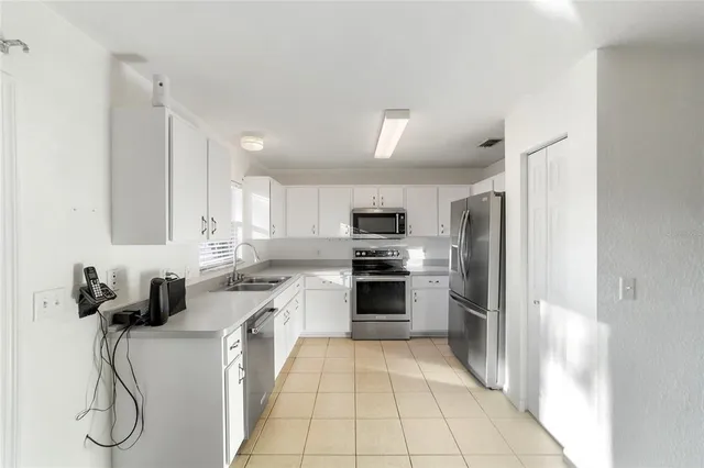 a kitchen with a refrigerator stove and sink