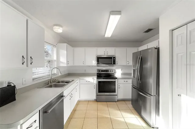 a kitchen with a stove and white cabinets