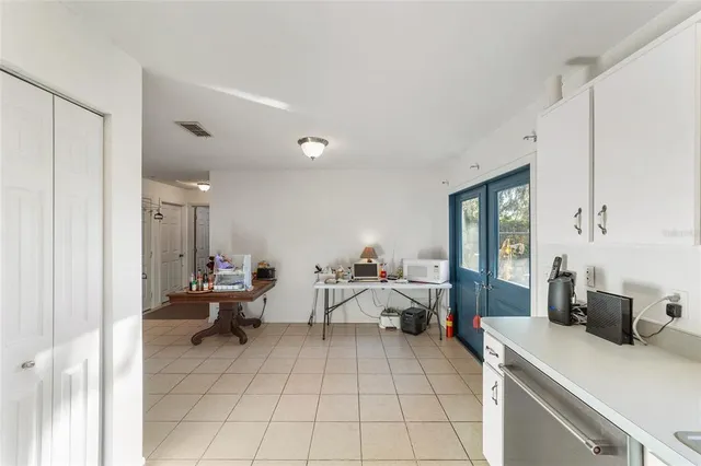 a kitchen with stainless steel appliances kitchen island granite countertop a refrigerator and a stove top oven