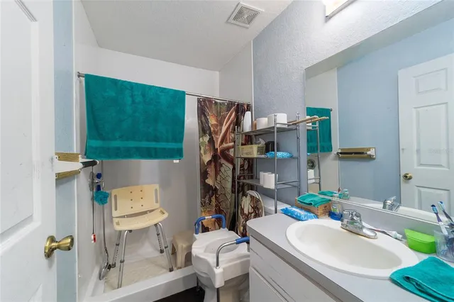 a bedroom with furniture and a flat screen tv