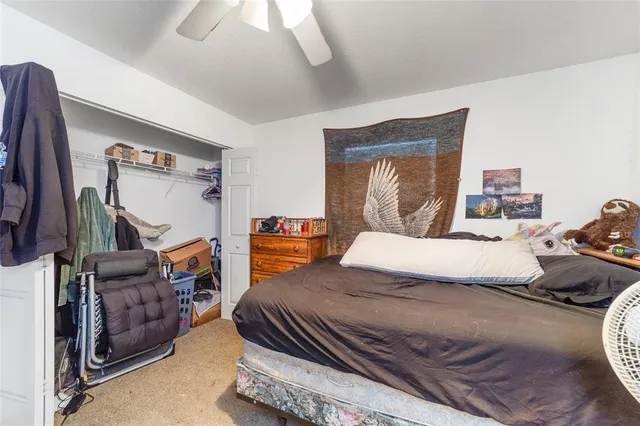 a bedroom with furniture and a flat screen tv