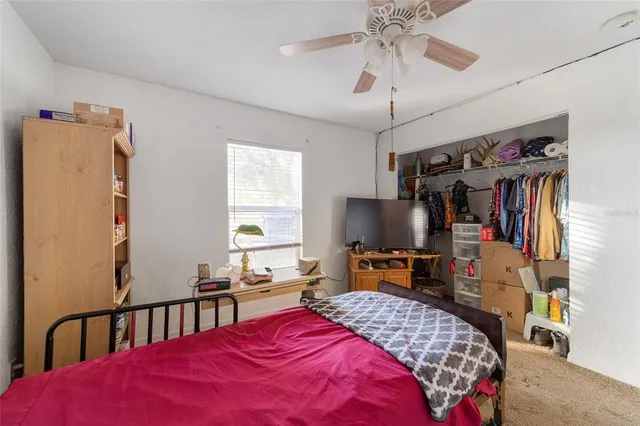 a bedroom with a large bed and a chandelier