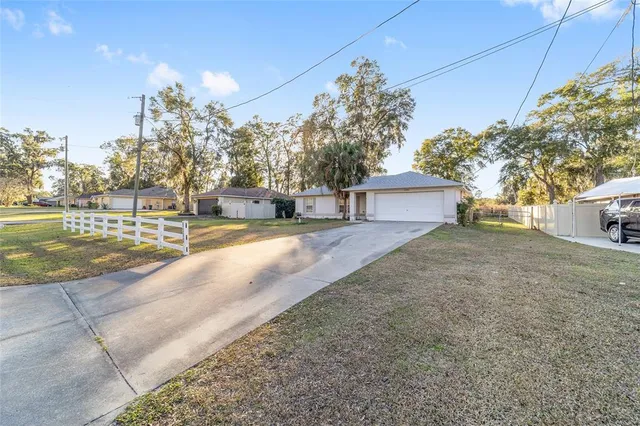 front view of a house with a yard and trees
