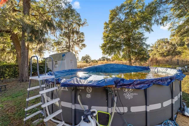 a view of a house with backyard and sitting area