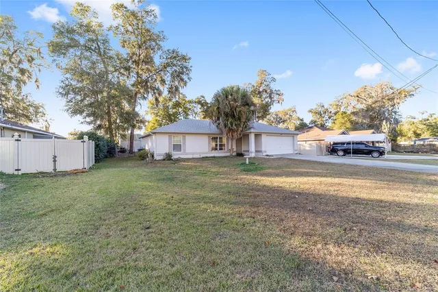 a backyard of a house with table and chairs