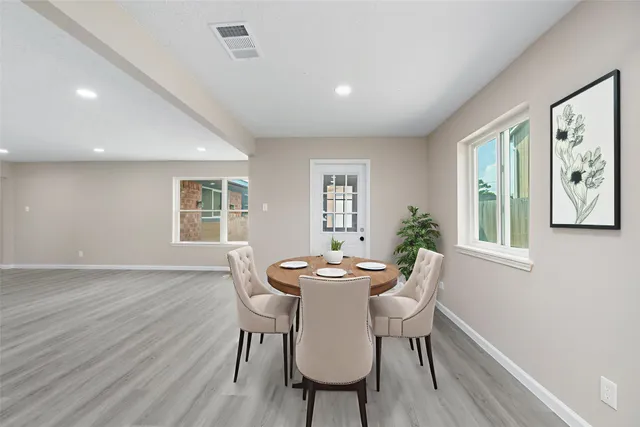 a dining room with furniture and wooden floor