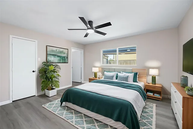 a bedroom with a bed table and a window