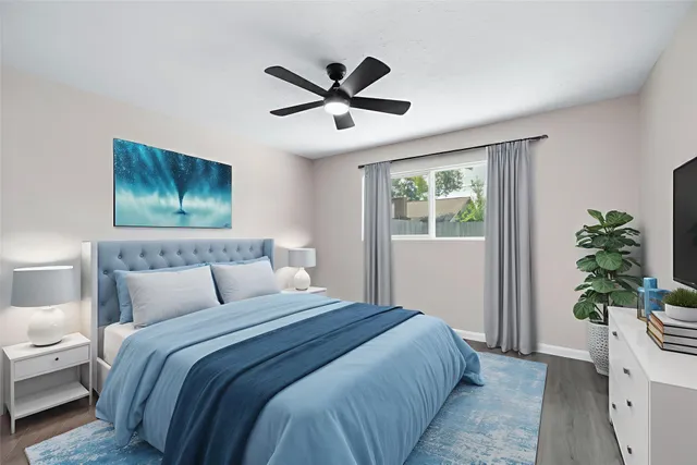 a bedroom with a large bed and a chandelier