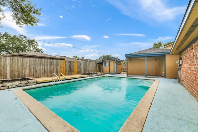 a view of a backyard with swimming pool
