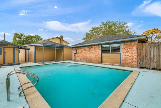 a view of a backyard with a barbeque grill and plants