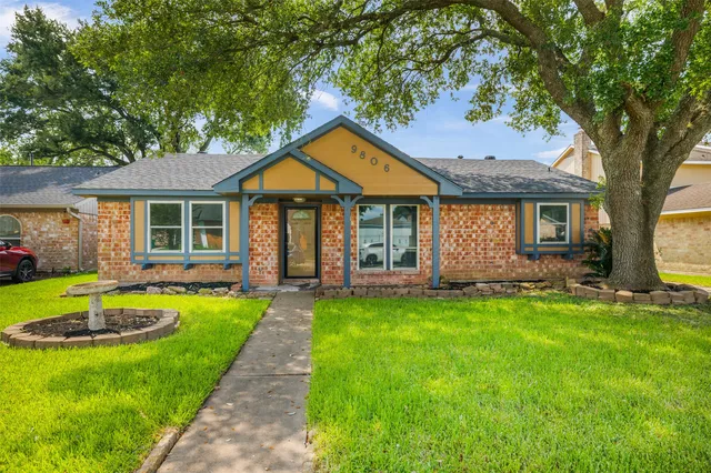 a front view of a house with a yard table and chairs