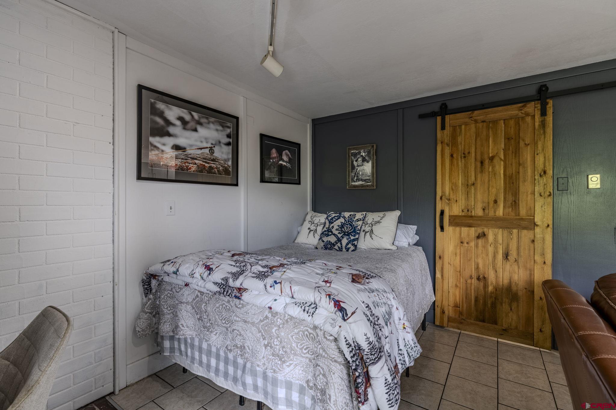 395 Sheol Street, Unit 109 Durango, CO 81301 - Photo 13 of 30 a bedroom with a bed and a painting on the wall