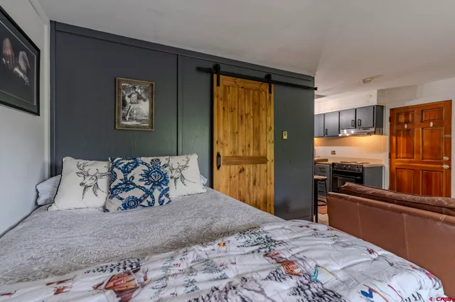 a large bed sitting in a bedroom next to a window