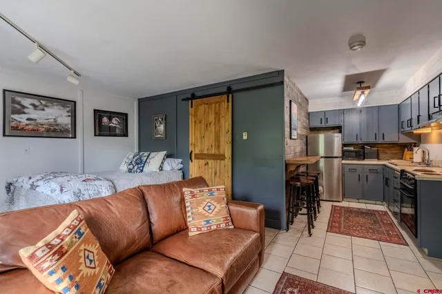a living room with furniture and kitchen view