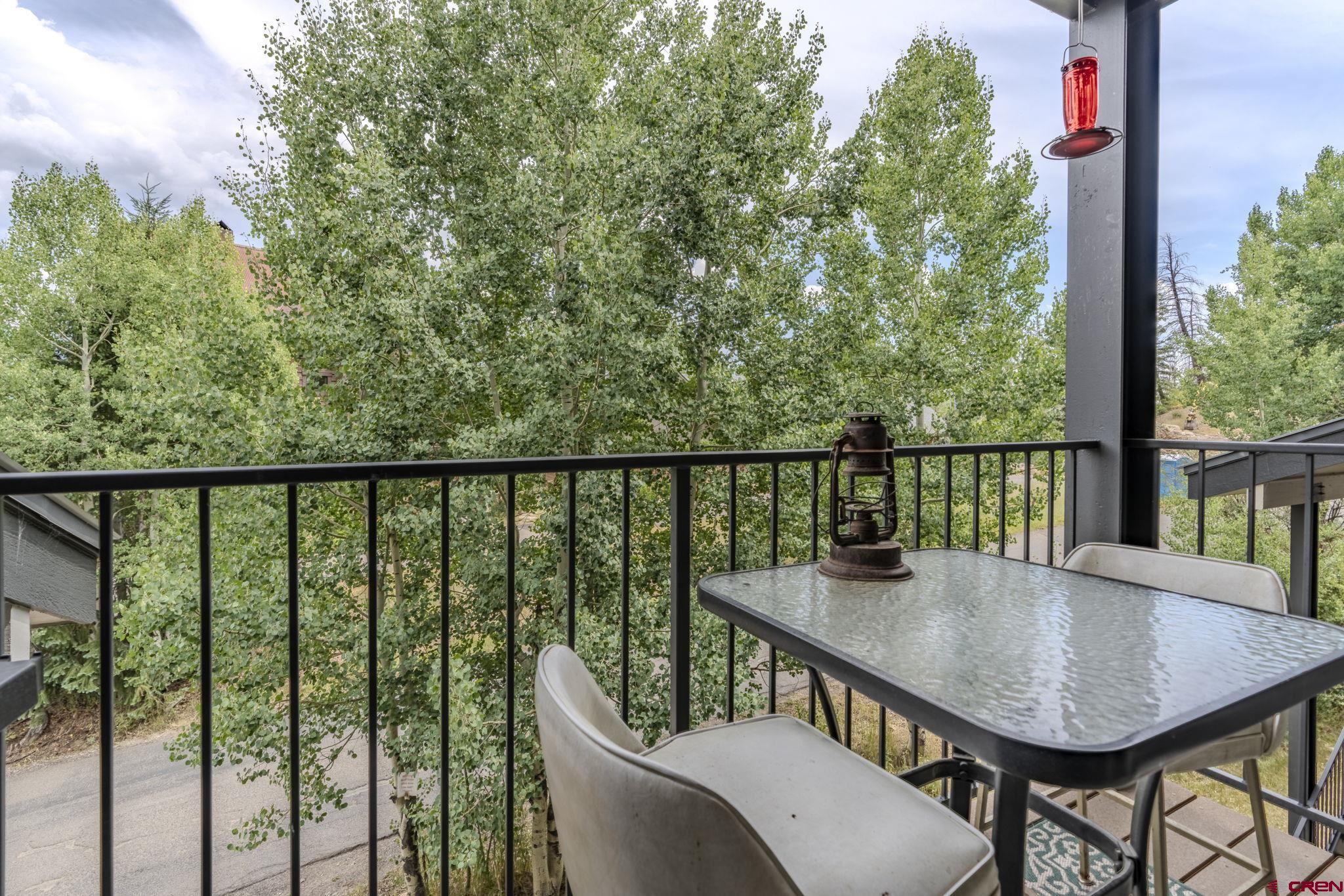 395 Sheol Street, Unit 109 Durango, CO 81301 - Photo 18 of 30 a view of a balcony with wooden floor table and chairs