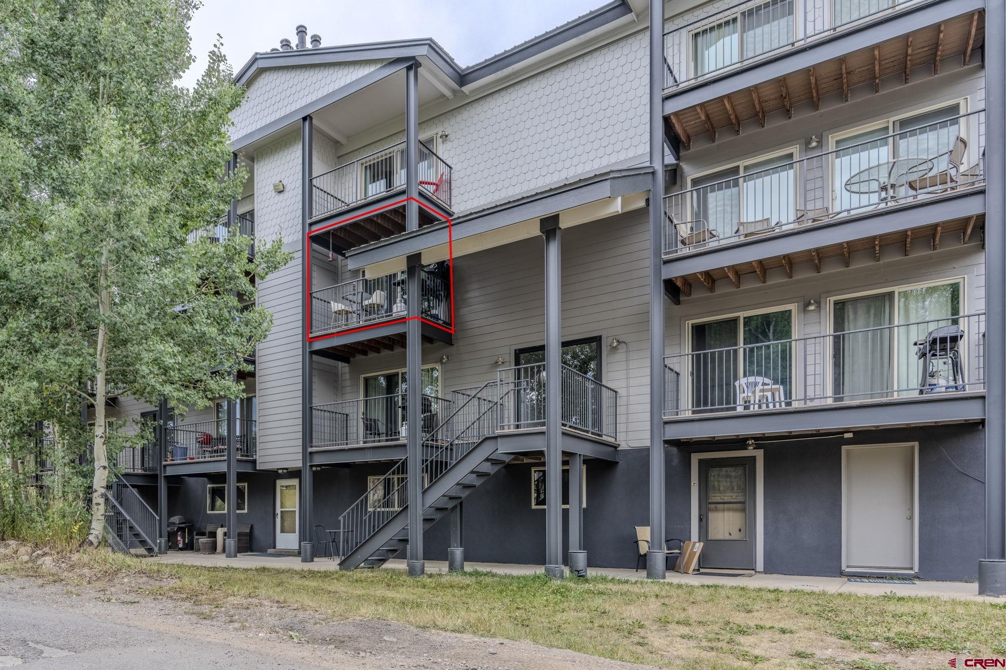 395 Sheol Street, Unit 109 Durango, CO 81301 - Photo 19 of 30 a front view of a residential apartment building with a yard