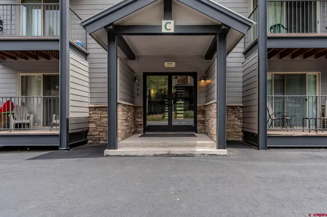 a view of a house with a door and wooden floor