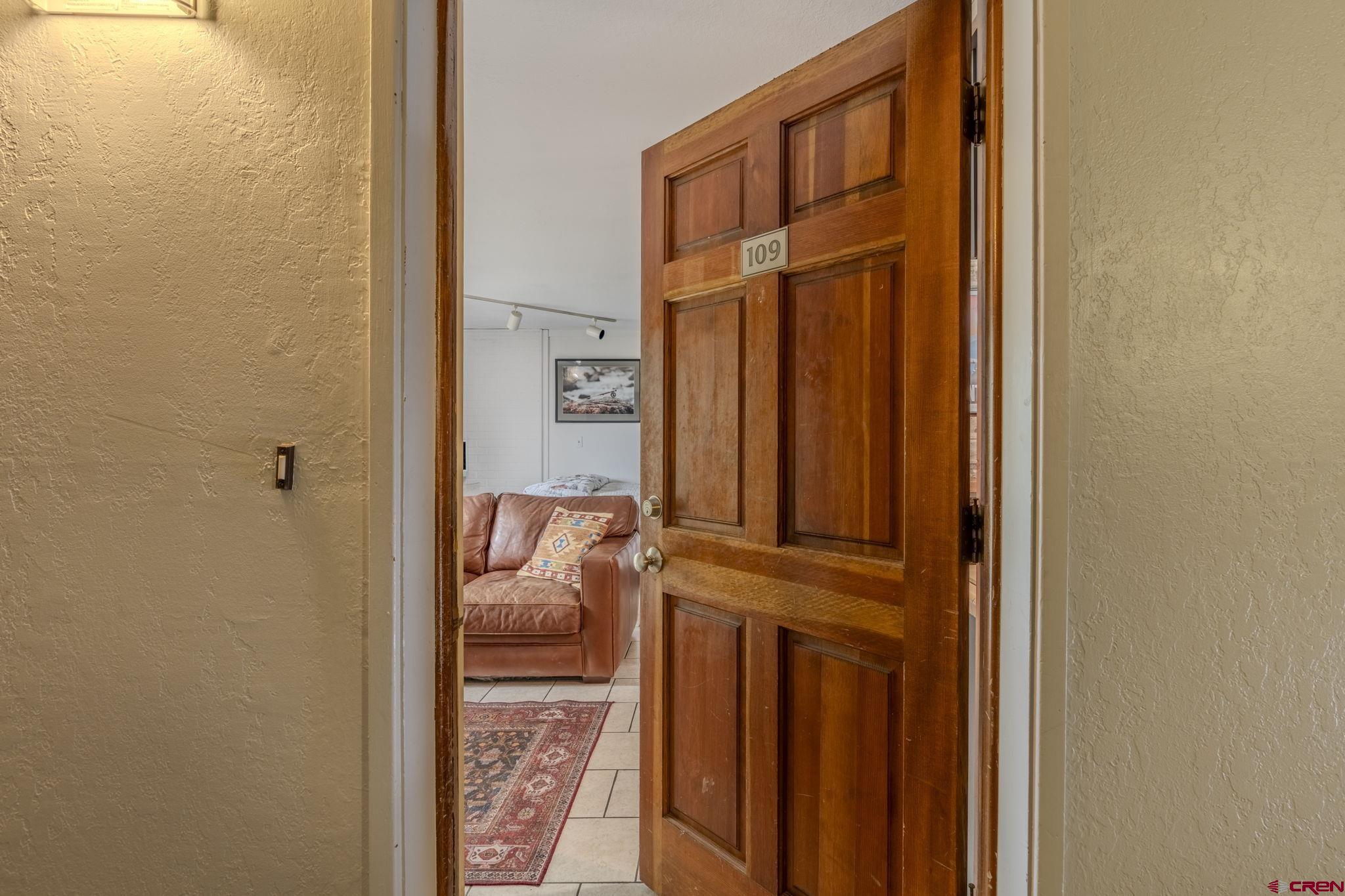 395 Sheol Street, Unit 109 Durango, CO 81301 - Photo 3 of 30 a view of a hallway with a door and wooden floor