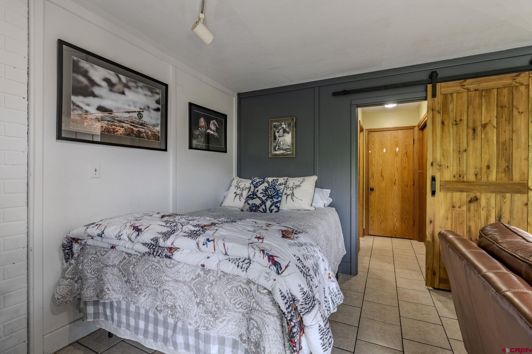 395 Sheol Street, Unit 109 Durango, CO 81301 - Photo 5 of 30 a bedroom with a bed and a painting on the wall