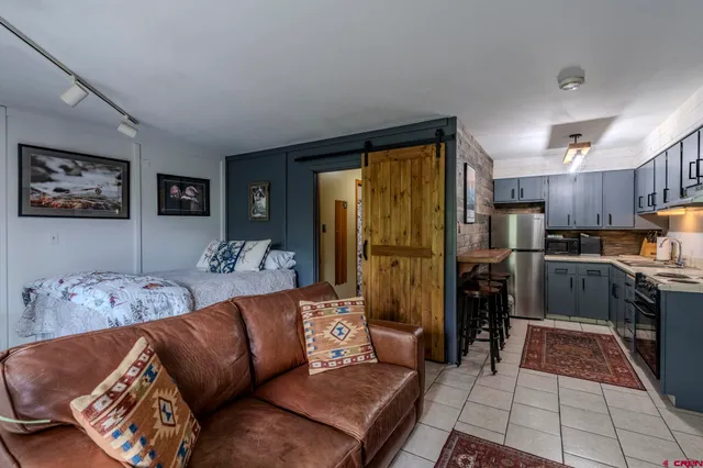 a living room with furniture and kitchen view