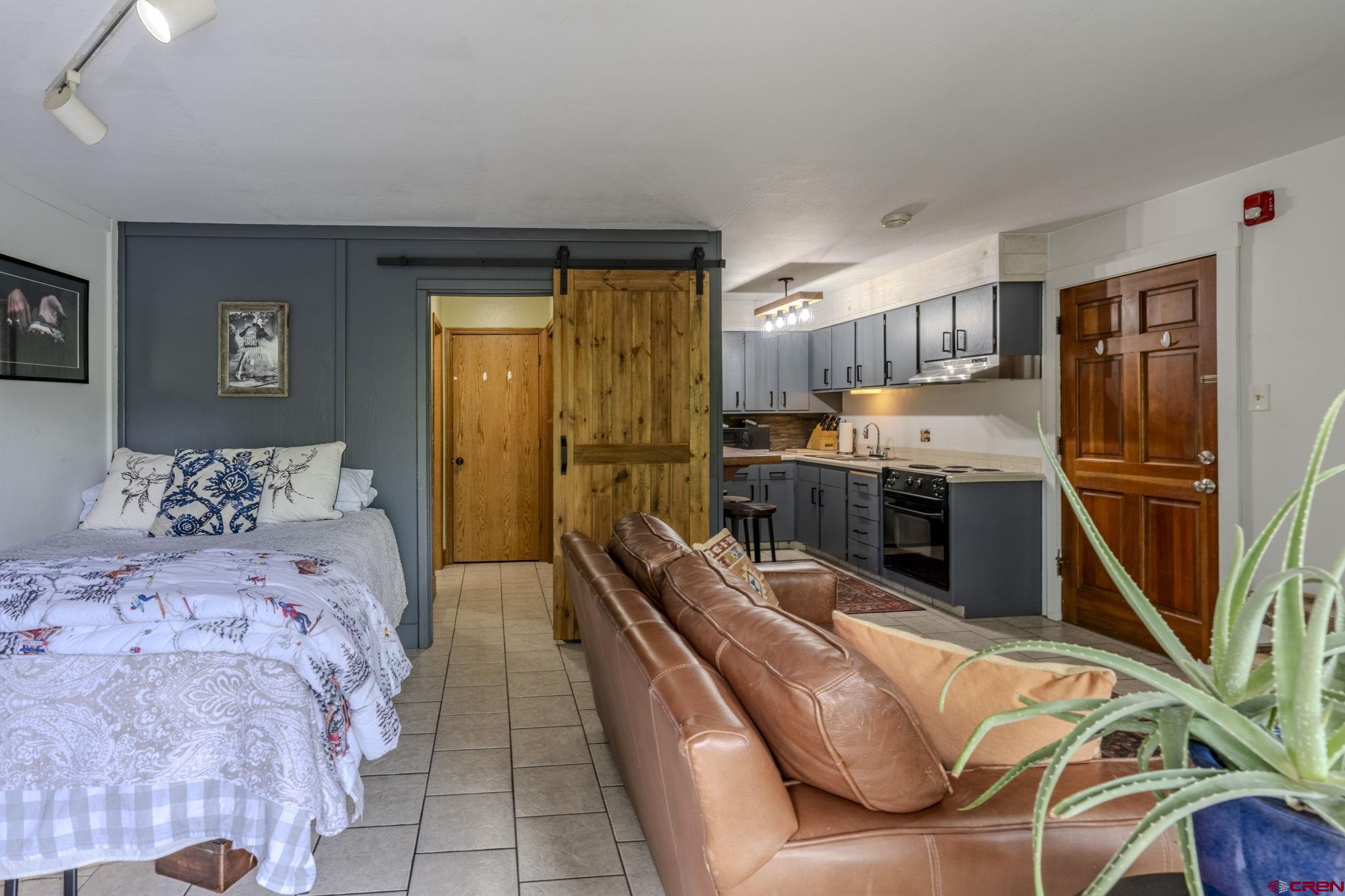 395 Sheol Street, Unit 109 Durango, CO 81301 - Photo 7 of 30 a bedroom with bed furniture and a window