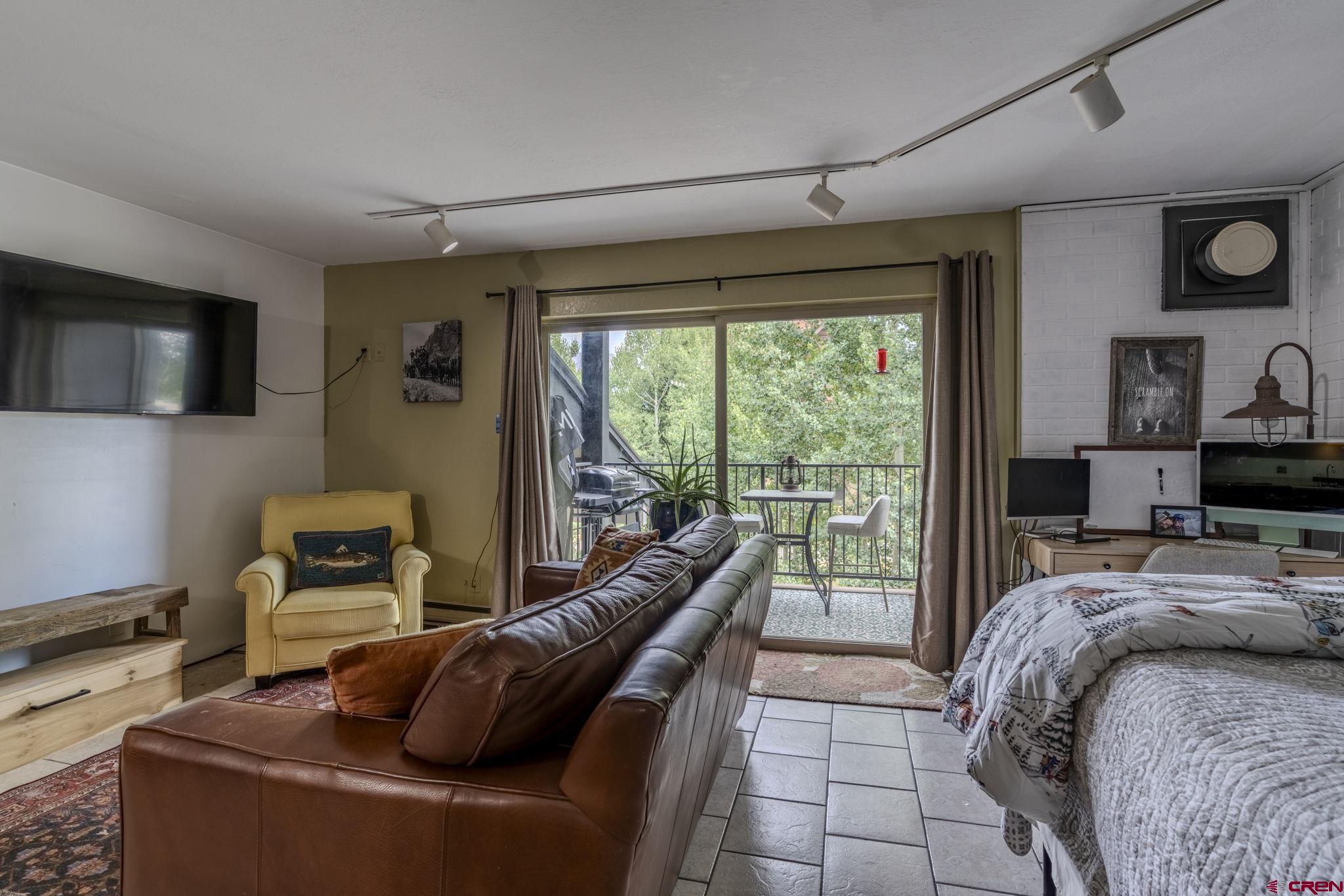 395 Sheol Street, Unit 109 Durango, CO 81301 - Photo 9 of 30 a bedroom with a bed and wooden floor