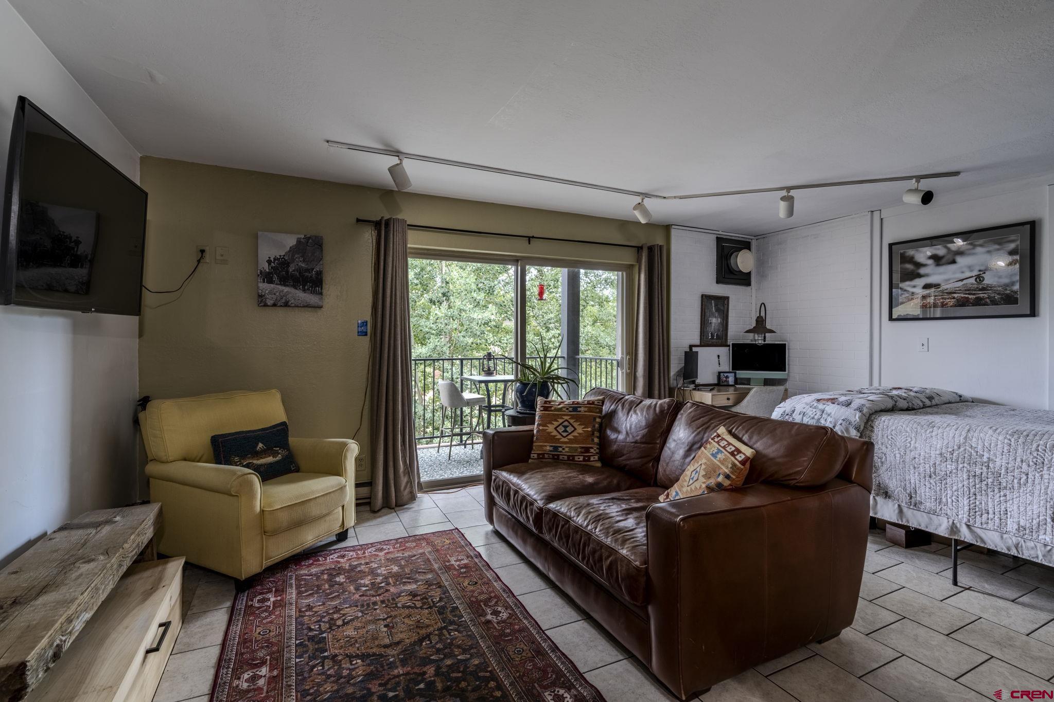 395 Sheol Street, Unit 109 Durango, CO 81301 - Photo 10 of 30 a living room with furniture and a flat screen tv