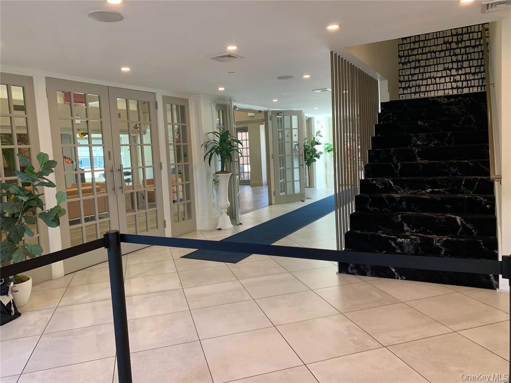 1338 Robin Lane, Unit 1212 Queens, NY 11360 - Photo 13 of 22 a view of an entryway with a floor to ceiling window and stairs