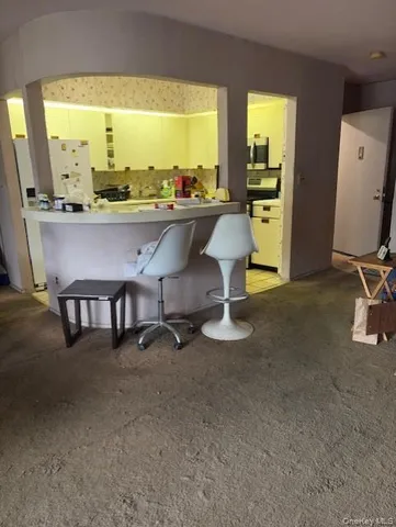 a balcony with wooden floor and fence next to a yard