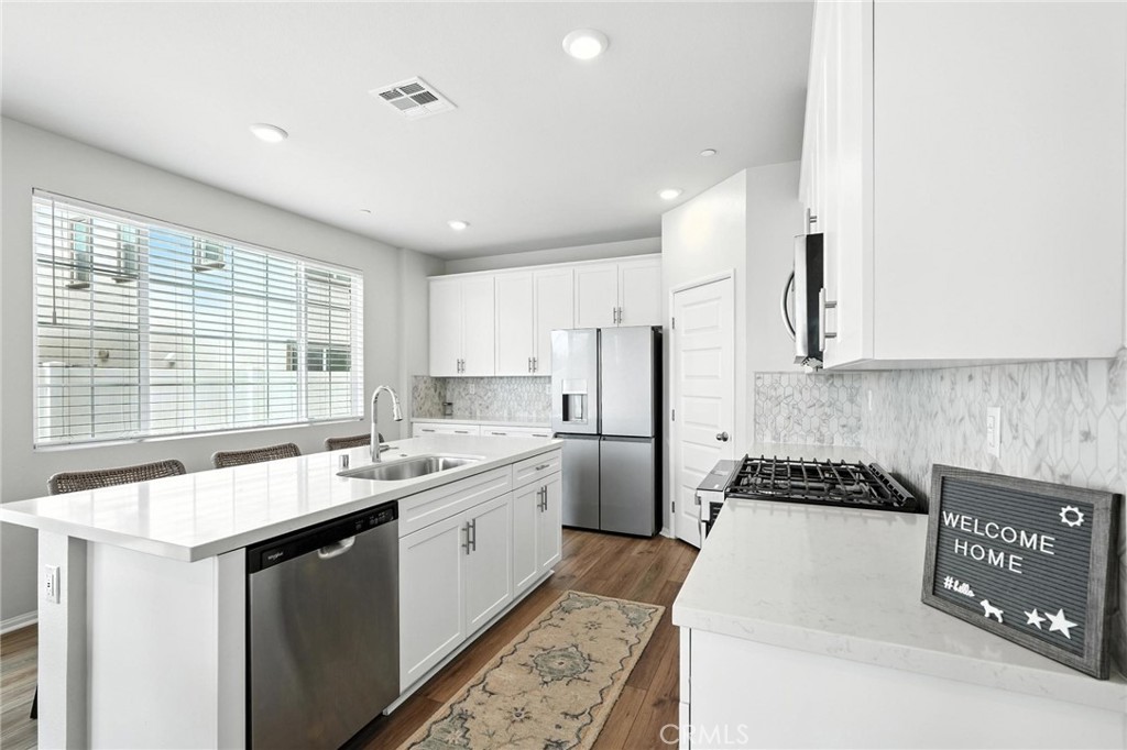 a kitchen with a sink stove and cabinets