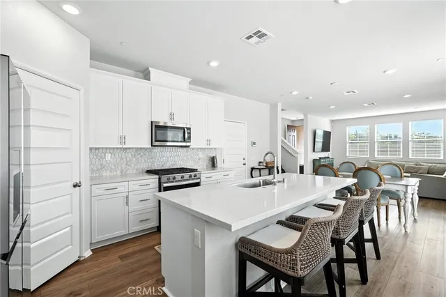 a large kitchen with a table and chairs