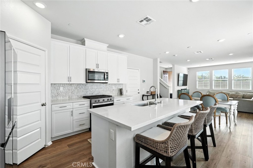 28267 Ashtree Street Temecula, CA 92591 - Photo 11 of 41 a large kitchen with a table and chairs
